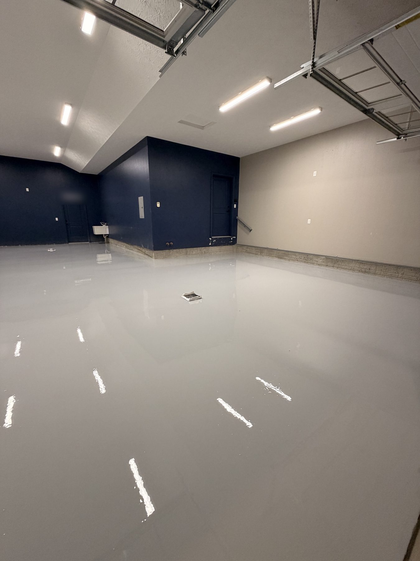 Light gray solid-color epoxy garage floor with a glossy finish