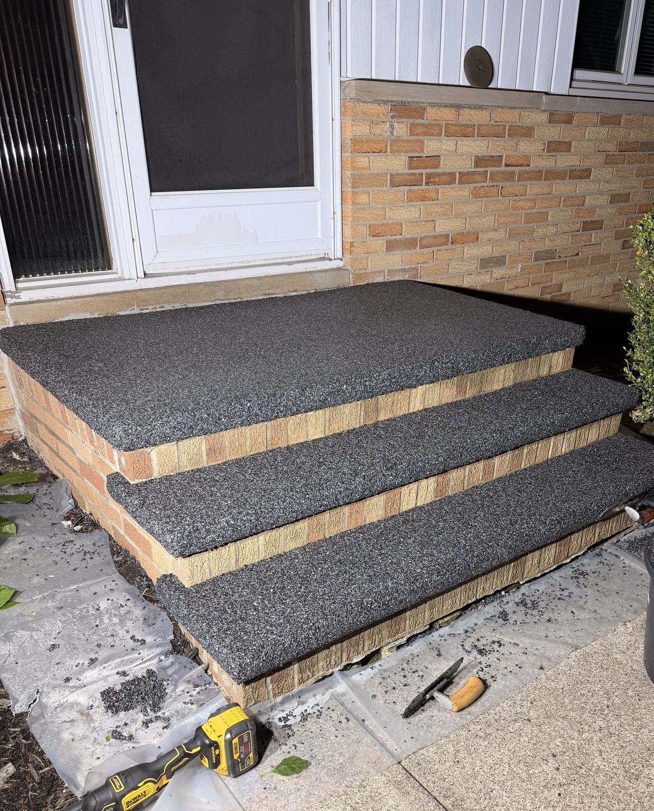 Front steps resurfaced with dark epoxy stone